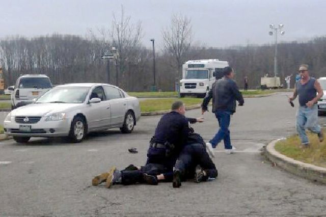 A cellphone photo of police "subduing a person," most likely Holmes, on the CSI campus yesterday